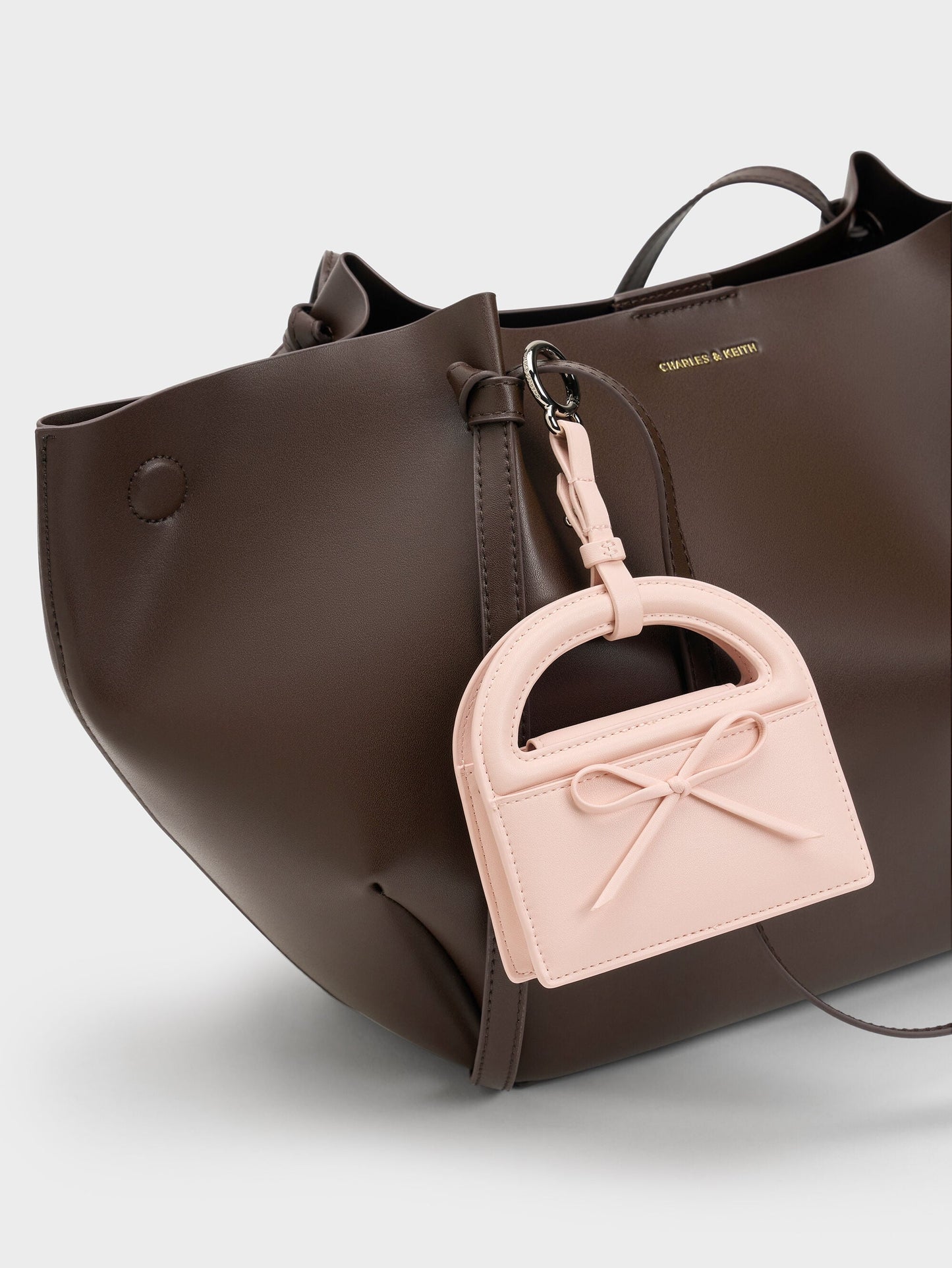 Reese Bow Top Handle Wristlet - Soft Pink | CHARLES & KEITH
