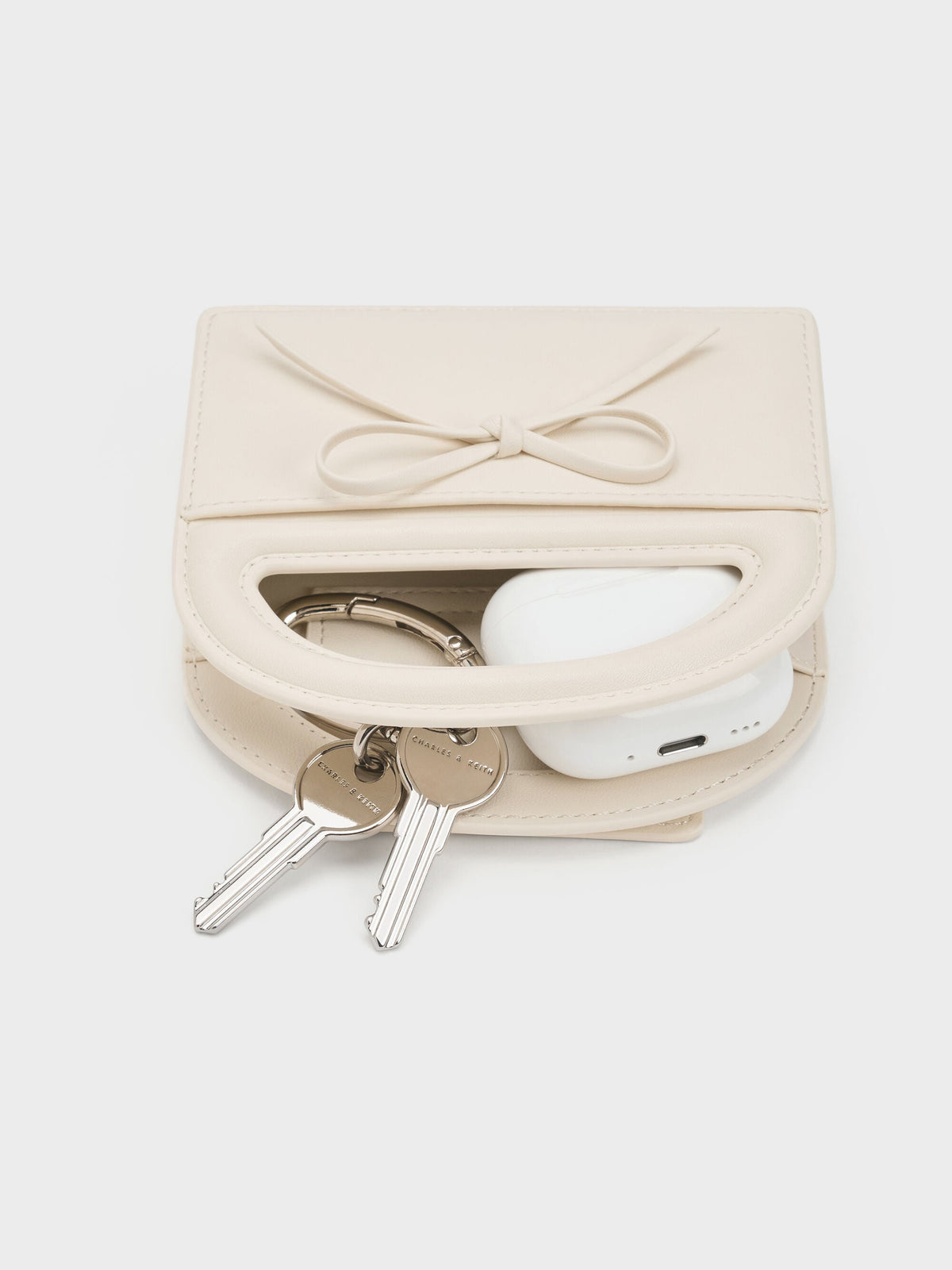 Reese Bow Top Handle Wristlet - Cream | CHARLES & KEITH