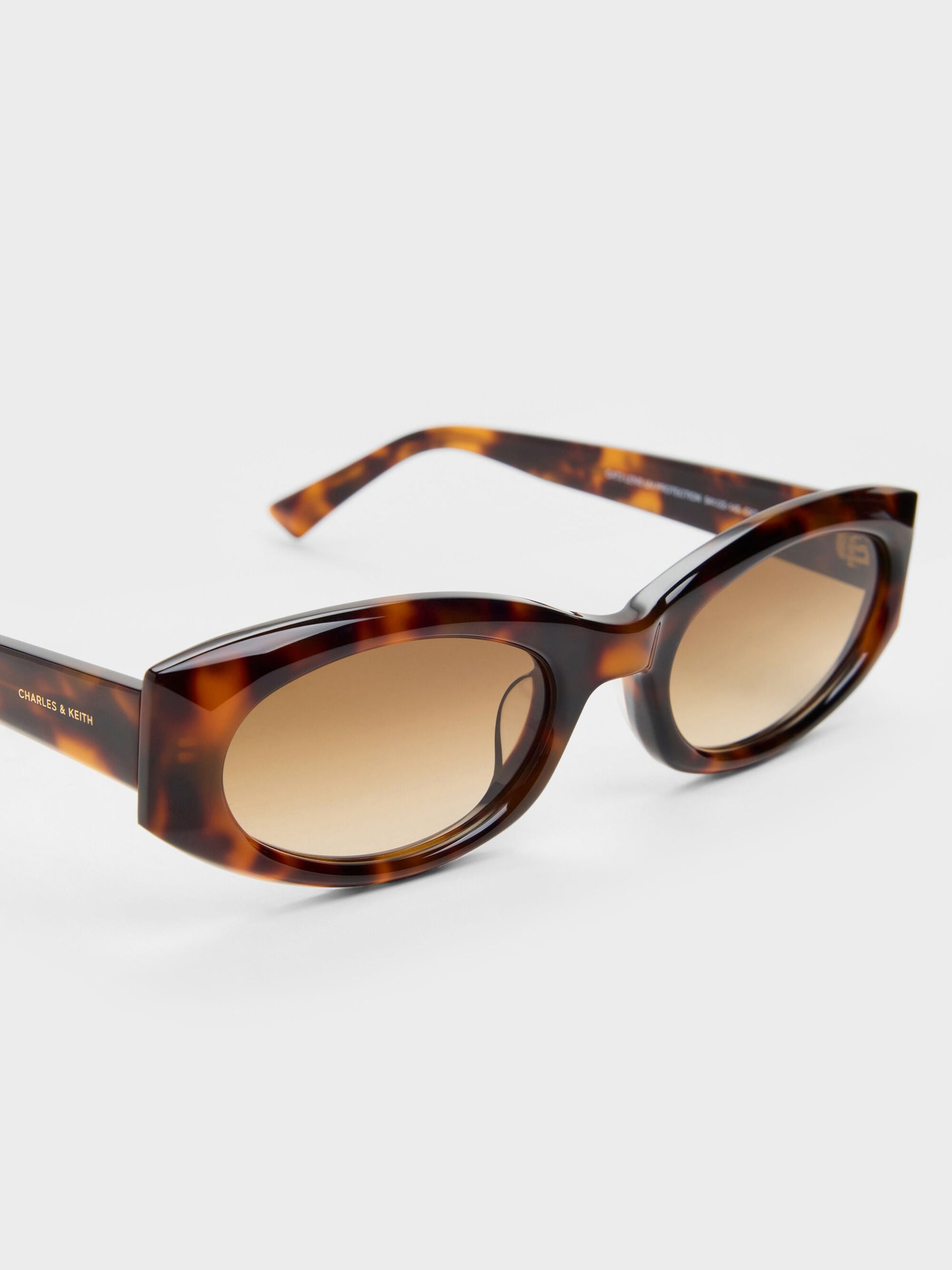Aubrey Oval Sunglasses - T. Shell | CHARLES & KEITH