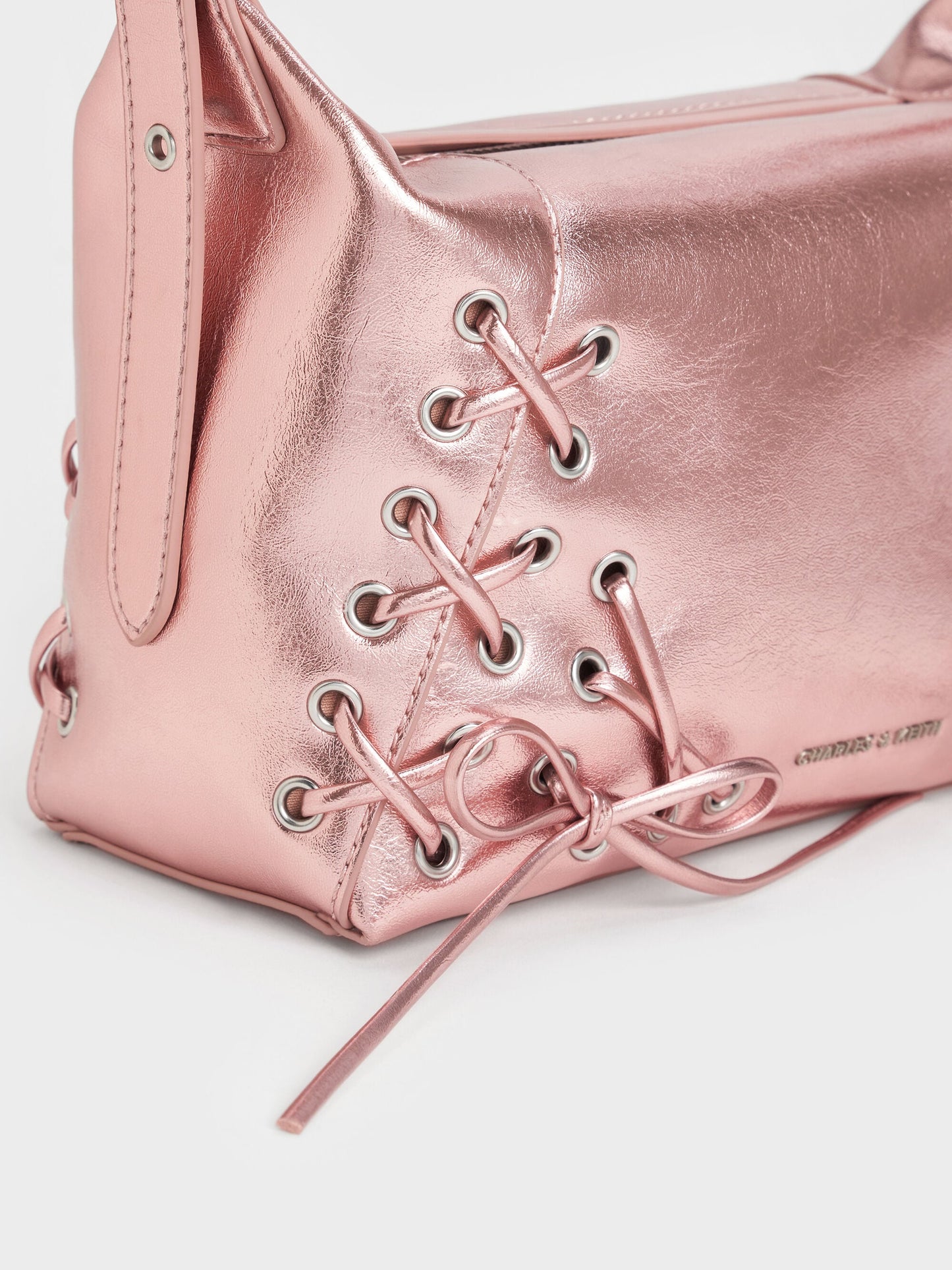 Xylia Metallic Grommet Lace-Up Shoulder Bag - Aura Pink | CHARLES & KEITH